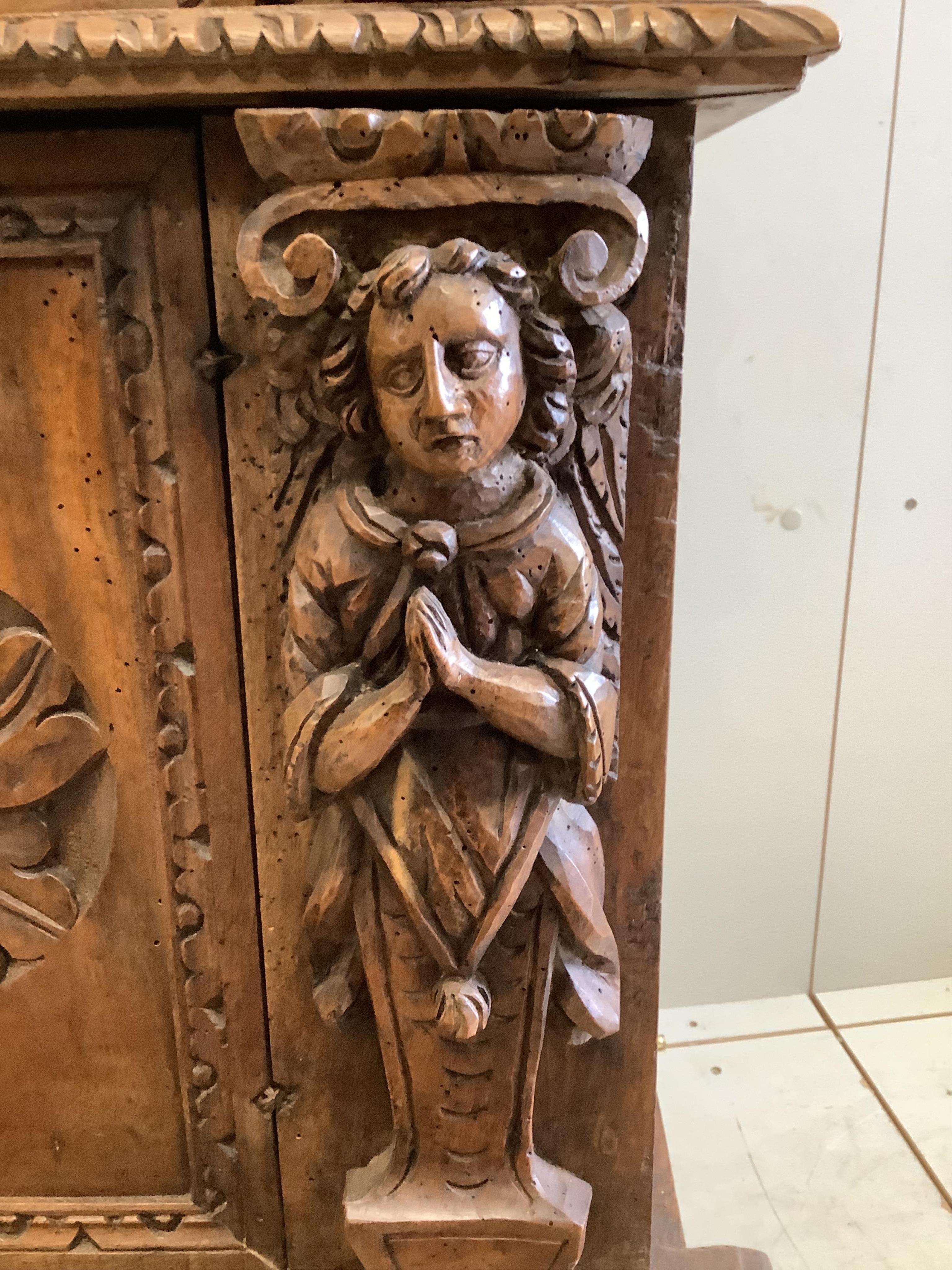 An 18th century style Continental carved walnut prie dieu cabinet, width 72cm, depth 49cm, height 90cm. Condition - poor to fair